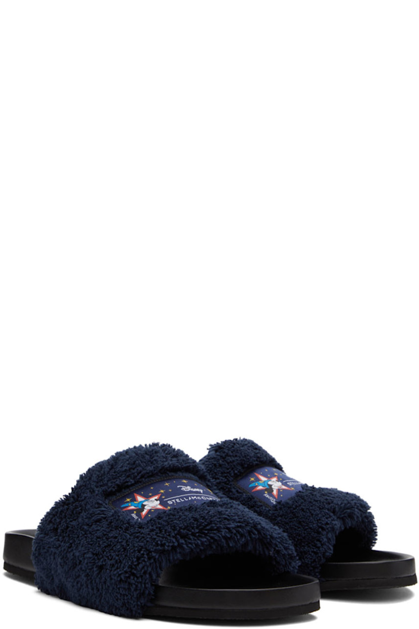 Faux-leather slip-on flat sandals in black. Padded terrycloth strap in navy with textile logo graphic patch at vamp.

· Logo embossed at molded footbed
· Textured rubber sole

Made from cruelty-free, non-animal materials.

Part of the Stella McCartney Disney Fantasia capsule collection.

Supplier color: Navy