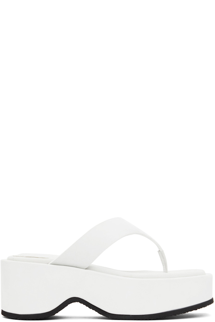 Suede slip-on sandals in grey.

· Open square toe
· Thong-style strap at vamp 
· Logo stamp at padded leather footbed 
· Suede-covered platform foam rubber midsole
· Treaded rubber outsole 
· Platform: H2.5 in 

Wholesale exclusivity at SSENSE.

Supplier color: White