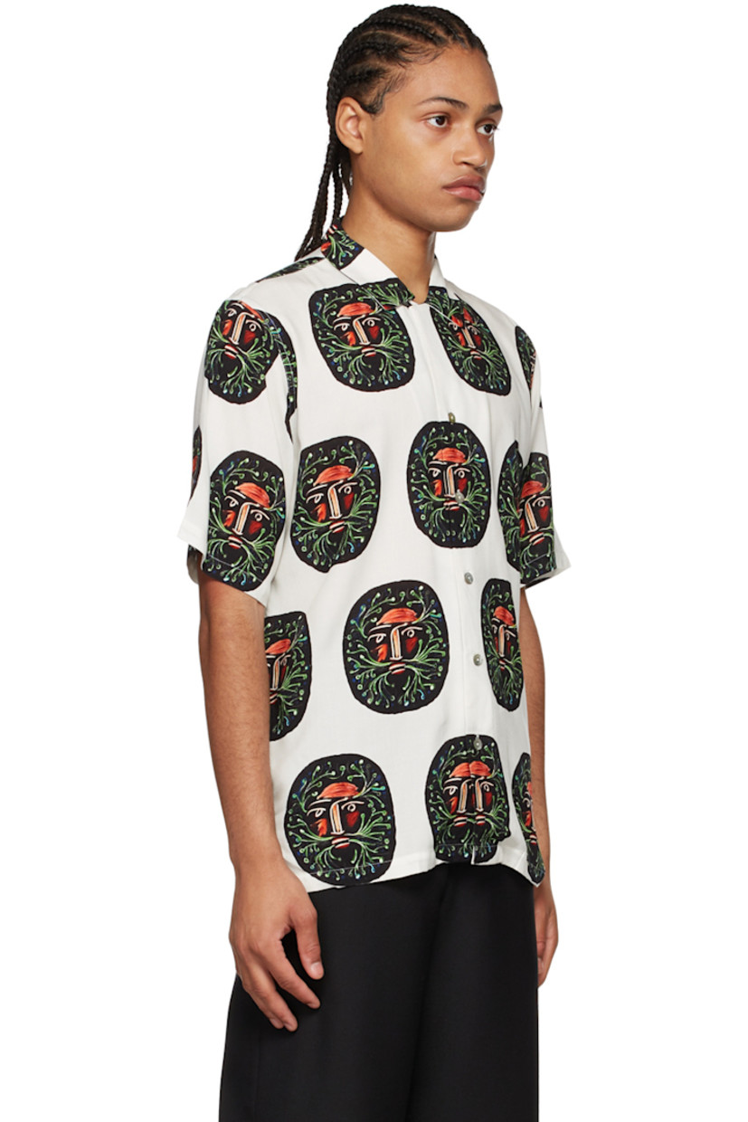 Plain-woven rayon shirt. Graphic pattern printed throughout.

· Open spread collar
· Button closure
· Vented side-seams 
· Mother-of-pearl hardware 

Supplier color: Cream