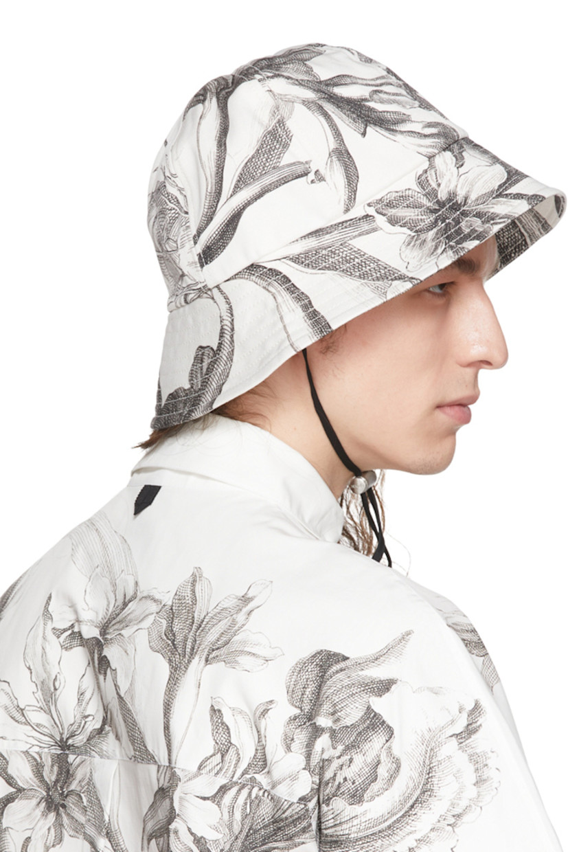 Paneled stretch denim bucket hat featuring graphic pattern printed throughout in black and white.  Adjustable chin strap with logo-engraved cord-lock fastening.

Supplier color: Botancial gabardine