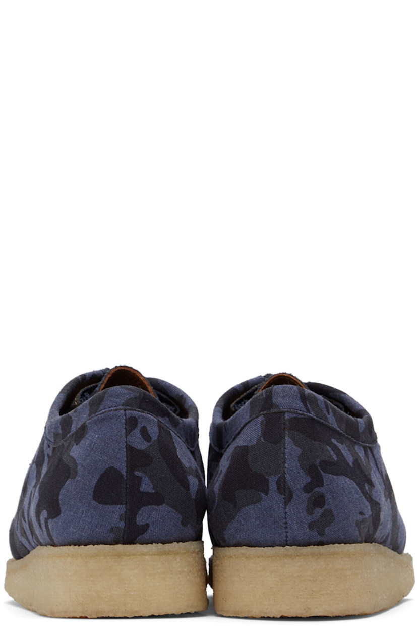 Low-top canvas derbys featuring graphic pattern in tones of blue. 

· Square moc toe 
· Lace-up closure 
· Grained leather lining in tan
· Crêpe rubber outsole 

Supplier color: Blue camo