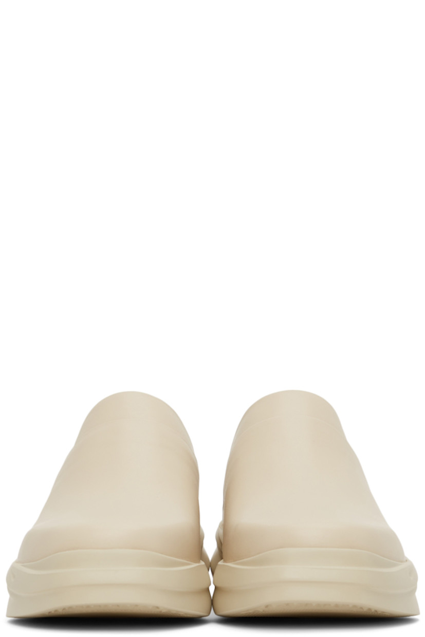 Buffed leather slip-on loafers in beige. 

· Square toe
· Logo embossed at heel counter and footbed
· Sculpted foam rubber midsole
· Treaded rubber outsole

Supplier color: Sand