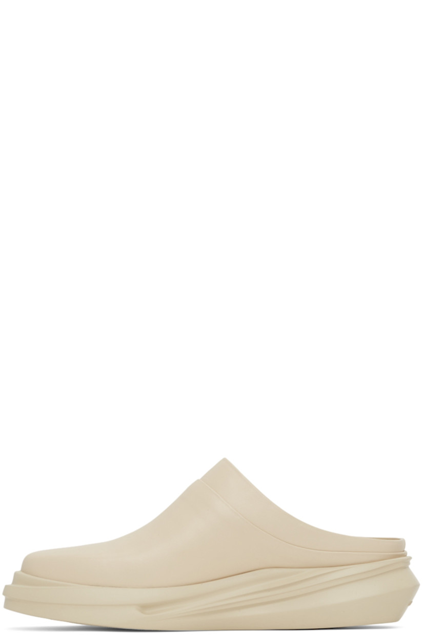 Buffed leather slip-on loafers in beige. 

· Square toe
· Logo embossed at heel counter and footbed
· Sculpted foam rubber midsole
· Treaded rubber outsole

Supplier color: Sand