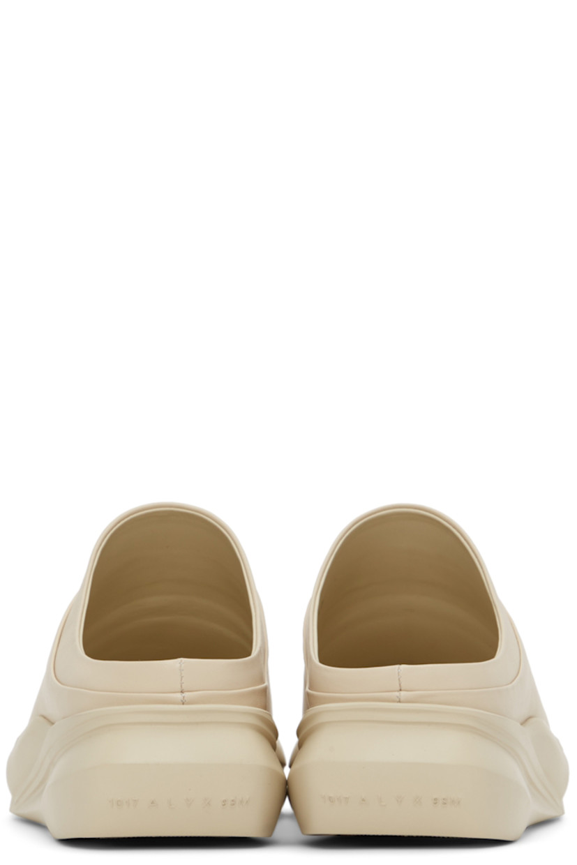 Buffed leather slip-on loafers in beige. 

· Square toe
· Logo embossed at heel counter and footbed
· Sculpted foam rubber midsole
· Treaded rubber outsole

Supplier color: Sand