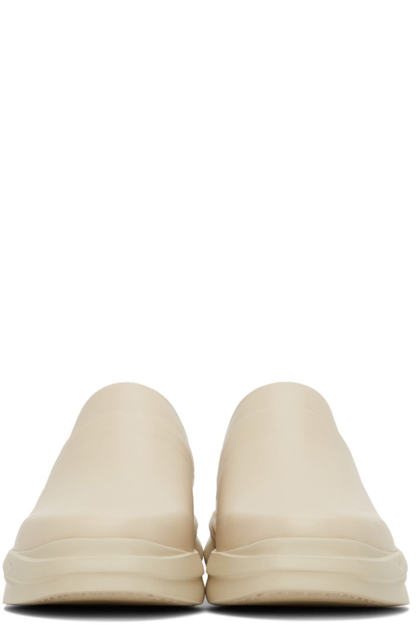 Buffed leather slip-on loafers in beige. 

· Square toe
· Logo embossed at heel counter and footbed
· Sculpted foam rubber midsole
· Treaded rubber outsole

Supplier color: Sand