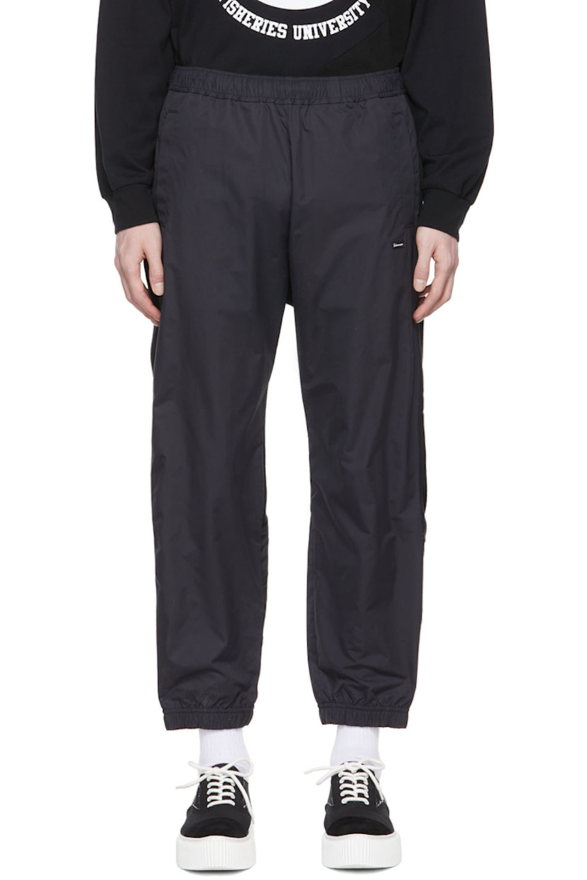 Paneled nylon canvas and French terry lounge pants.

· Concealed drawstring at elasticized waistband
· Textile logo patch at front
· Logo graphic printed at back
· Three-pocket styling

Supplier color: Black