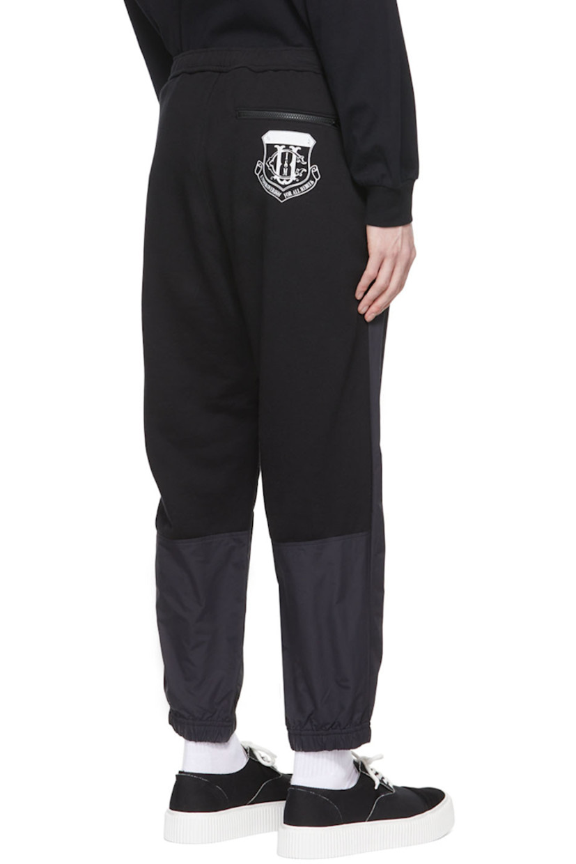 Paneled nylon canvas and French terry lounge pants.

· Concealed drawstring at elasticized waistband
· Textile logo patch at front
· Logo graphic printed at back
· Three-pocket styling

Supplier color: Black