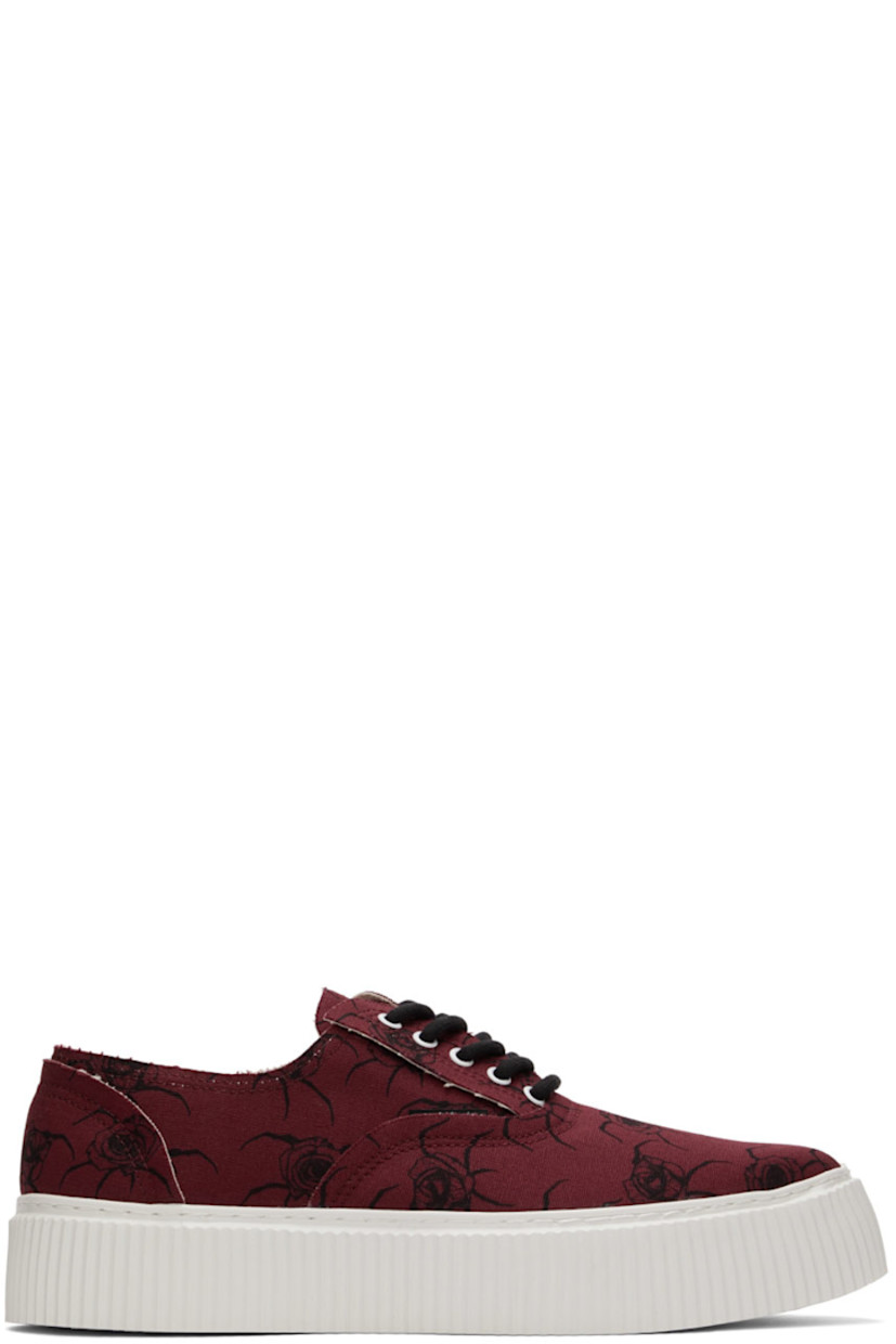 Low-top canvas sneakers in red featuring graphic pattern printed in black throughout. 

· Almond toe
· Lace-up closure
· Textured rubber platform midsole
· Treaded rubber outsole

Supplier color: Bordeaux base