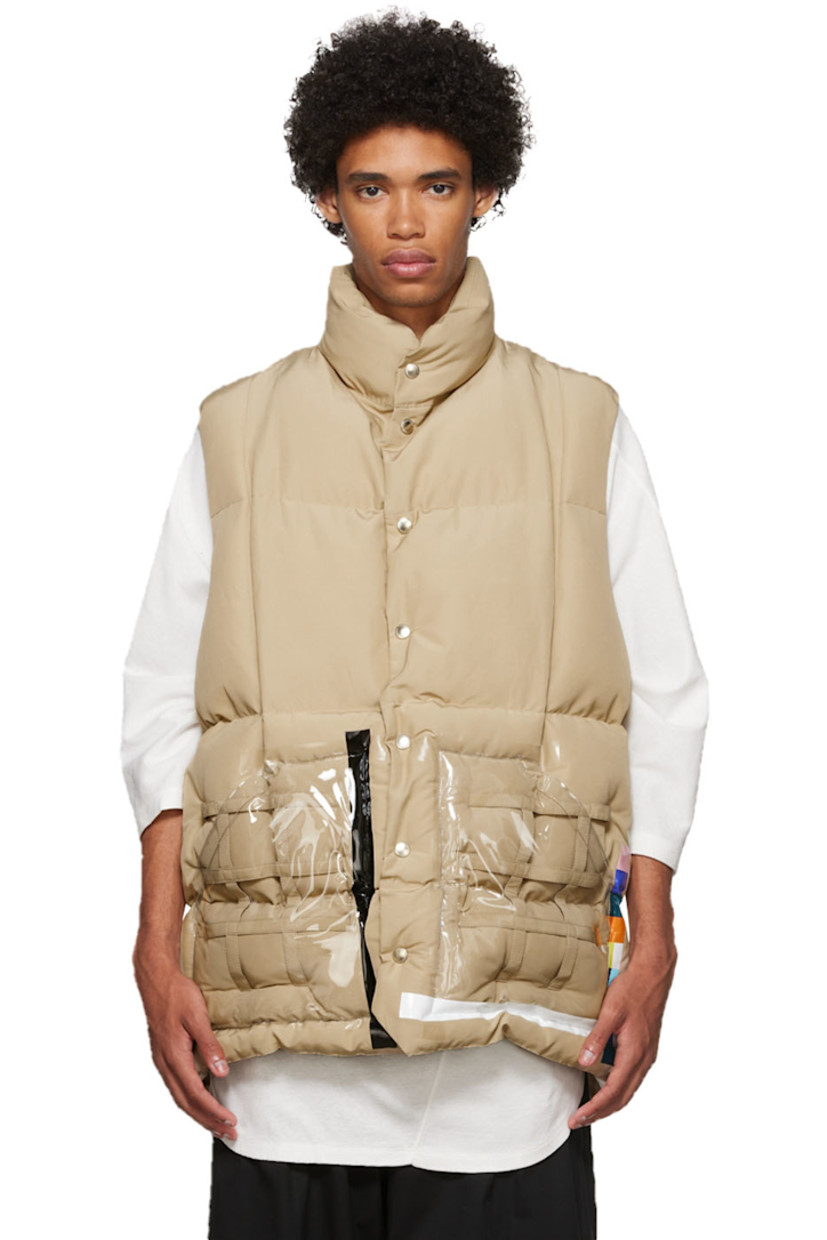 Primaloft® insulated quilted plain woven cotton and nylon-blend vest.

· Stand collar
· Button closure
· Straps and vinyl trim at transparent vinyl patch pockets
· Concealed drawstring at waist
· Nylon ripstop lining
· Logo-engraved silver-tone hardware

Supplier color: Beige
