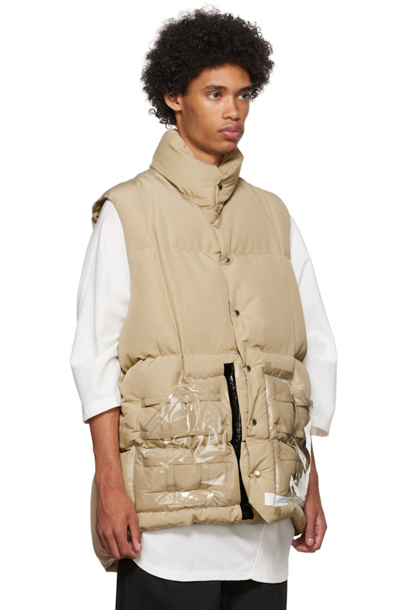 Primaloft® insulated quilted plain woven cotton and nylon-blend vest.

· Stand collar
· Button closure
· Straps and vinyl trim at transparent vinyl patch pockets
· Concealed drawstring at waist
· Nylon ripstop lining
· Logo-engraved silver-tone hardware

Supplier color: Beige