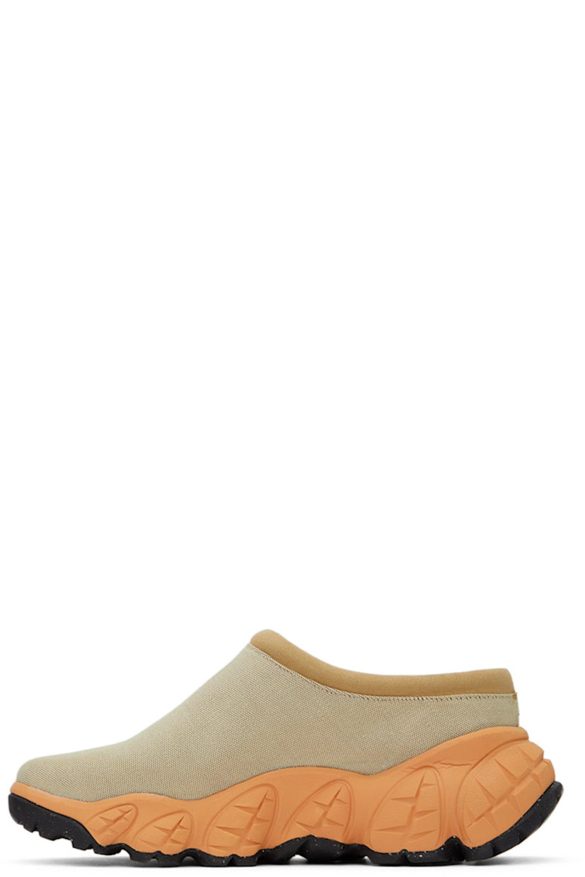 Low-top canvas slip-on sneakers in beige.

· Padded faux-suede tongue and collar 
· Logo hardware at side 
· Leather lining in white 
· Sculptural foam rubber midsole in orange
· Treaded Vibram® rubber outsole 

Supplier color: Tan