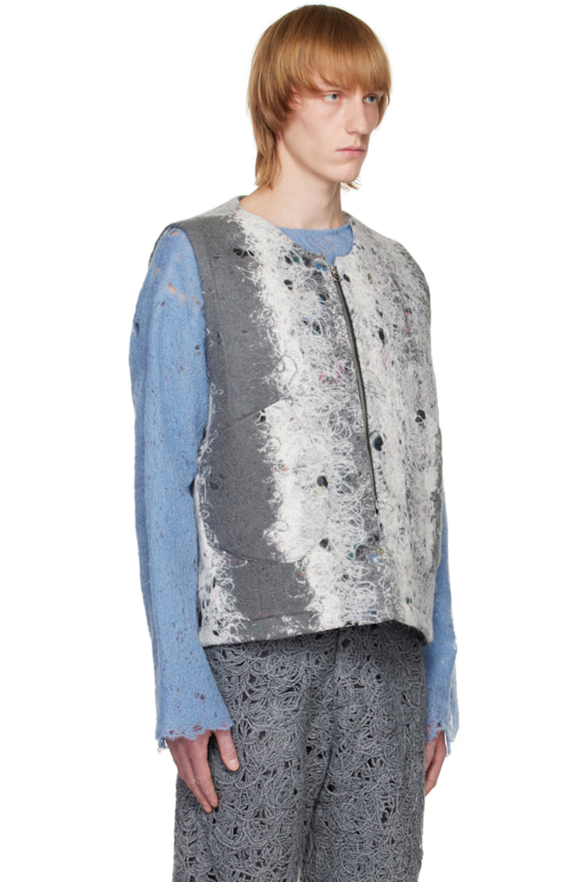 Felted regenerated wool-blend yarn vest. Distressing and graphic pattern throughout.

· V-neck
· Zip closure
· Patch pockets 
· Full plain-woven lining

Available exclusively at SSENSE. 

Supplier color: Grey/White mohair