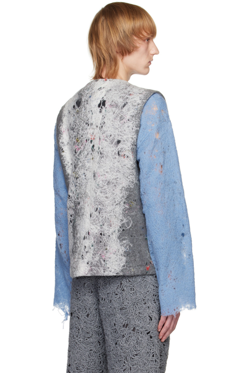 Felted regenerated wool-blend yarn vest. Distressing and graphic pattern throughout.

· V-neck
· Zip closure
· Patch pockets 
· Full plain-woven lining

Available exclusively at SSENSE. 

Supplier color: Grey/White mohair