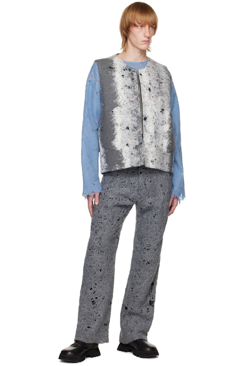 Felted regenerated wool-blend yarn vest. Distressing and graphic pattern throughout.

· V-neck
· Zip closure
· Patch pockets 
· Full plain-woven lining

Available exclusively at SSENSE. 

Supplier color: Grey/White mohair