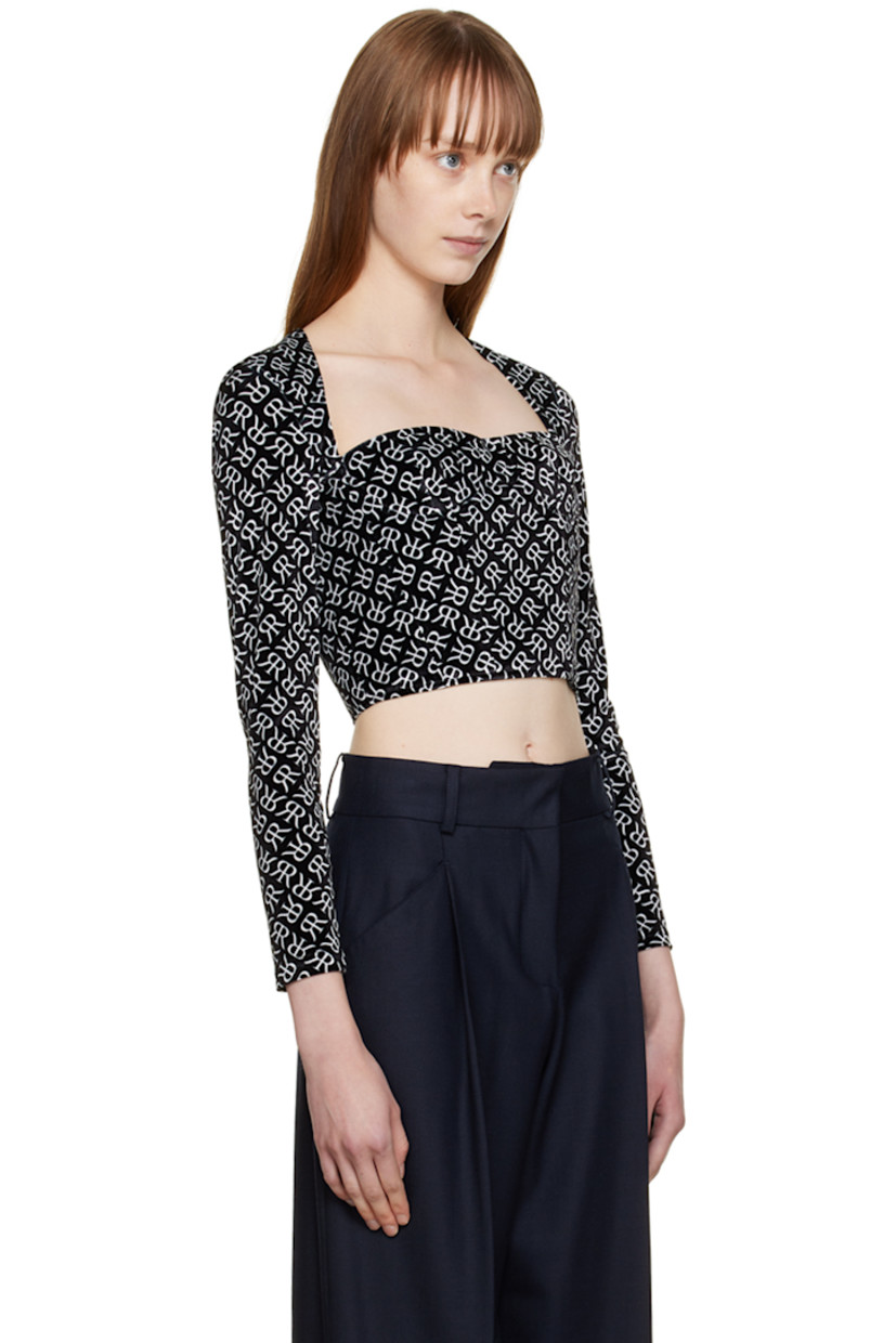 Polyester velvet blouse. Logo pattern printed throughout.

· Square neck 
· Underwire at cups
· Boning at front and back 
· Textile logo patch at cuff
· Zip closure at back

Supplier color: Black with white emblem