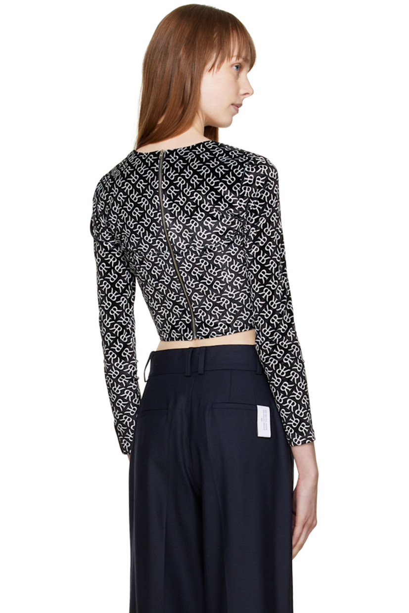 Polyester velvet blouse. Logo pattern printed throughout.

· Square neck 
· Underwire at cups
· Boning at front and back 
· Textile logo patch at cuff
· Zip closure at back

Supplier color: Black with white emblem