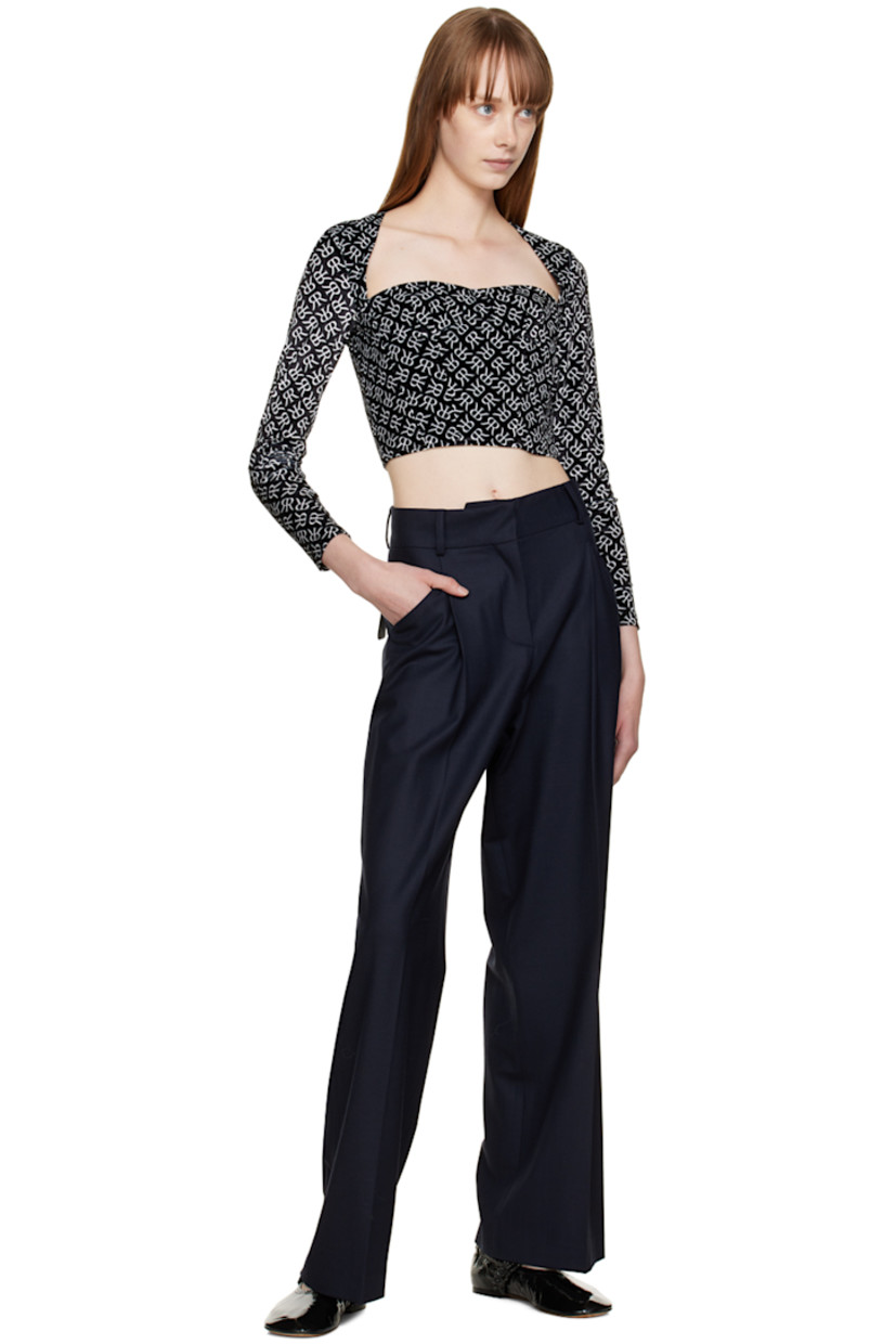 Polyester velvet blouse. Logo pattern printed throughout.

· Square neck 
· Underwire at cups
· Boning at front and back 
· Textile logo patch at cuff
· Zip closure at back

Supplier color: Black with white emblem