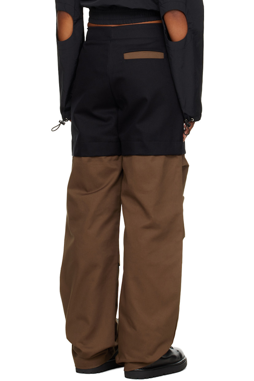 Cotton twill trousers.

· Cutout at waistband
· Five-pocket styling
· Zip-fly
· Storm flaps at front and back

Supplier color: Black/Brown