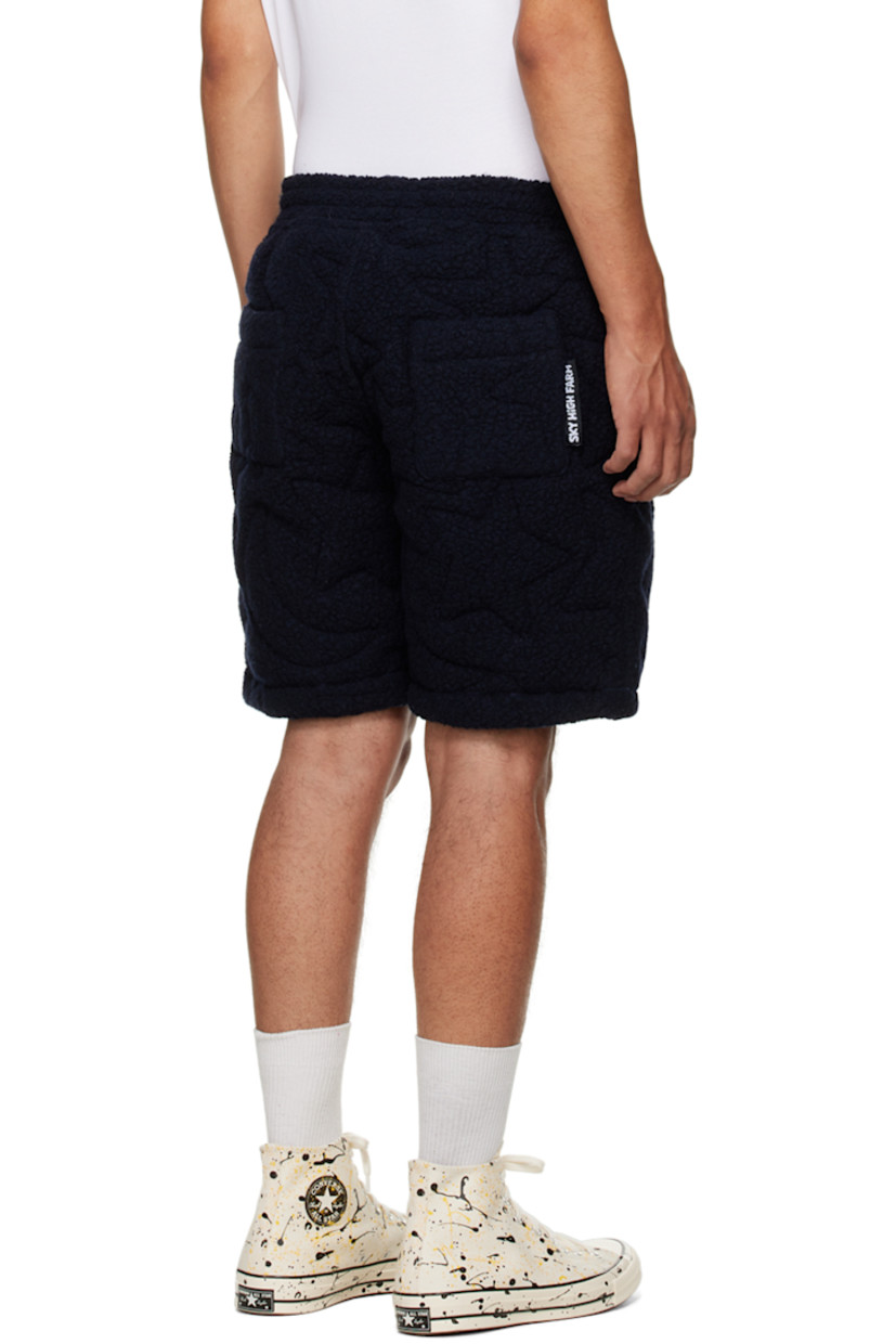 Insulated recycled wool-blend fleece shorts. Quilted graphic pattern throughout. 

· Drawstring at elasticized waistband
· Two-pocket styling
· Rubberized logo patch at front
· Full stretch cotton jersey lining

Supplier color: Navy