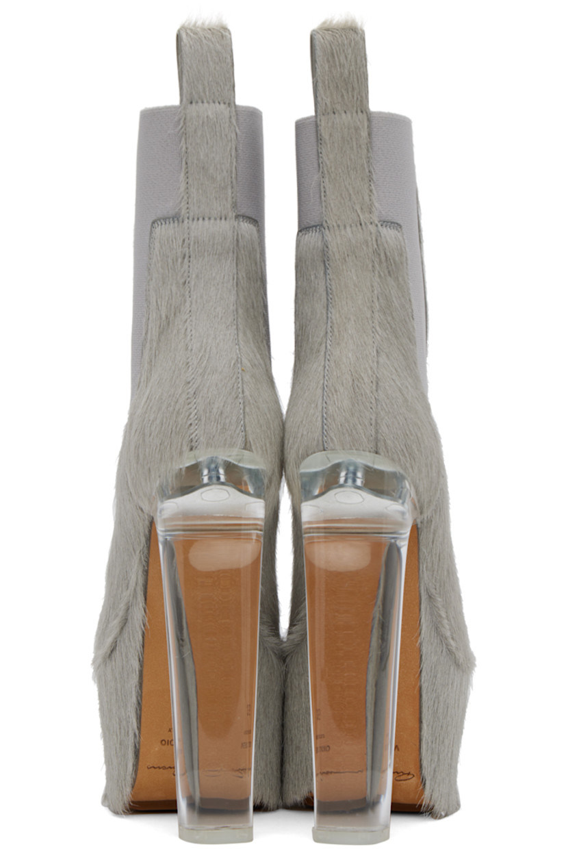 Ankle-high cow-hair boots in gray. 

· Cow-hair pull-loop at heel tab
· Elasticized gussets at sides
· Transparent plexiglass block heel with rubber injection
· Cow-hair covered platform 
· Leather sole with treaded rubber injection
· Platform: H2.75 in
· Heel: H6.5 in 

Supplier color: Pearl/Clear