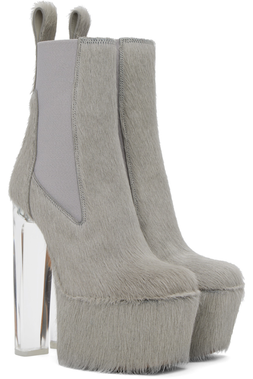 Ankle-high cow-hair boots in gray. 

· Cow-hair pull-loop at heel tab
· Elasticized gussets at sides
· Transparent plexiglass block heel with rubber injection
· Cow-hair covered platform 
· Leather sole with treaded rubber injection
· Platform: H2.75 in
· Heel: H6.5 in 

Supplier color: Pearl/Clear