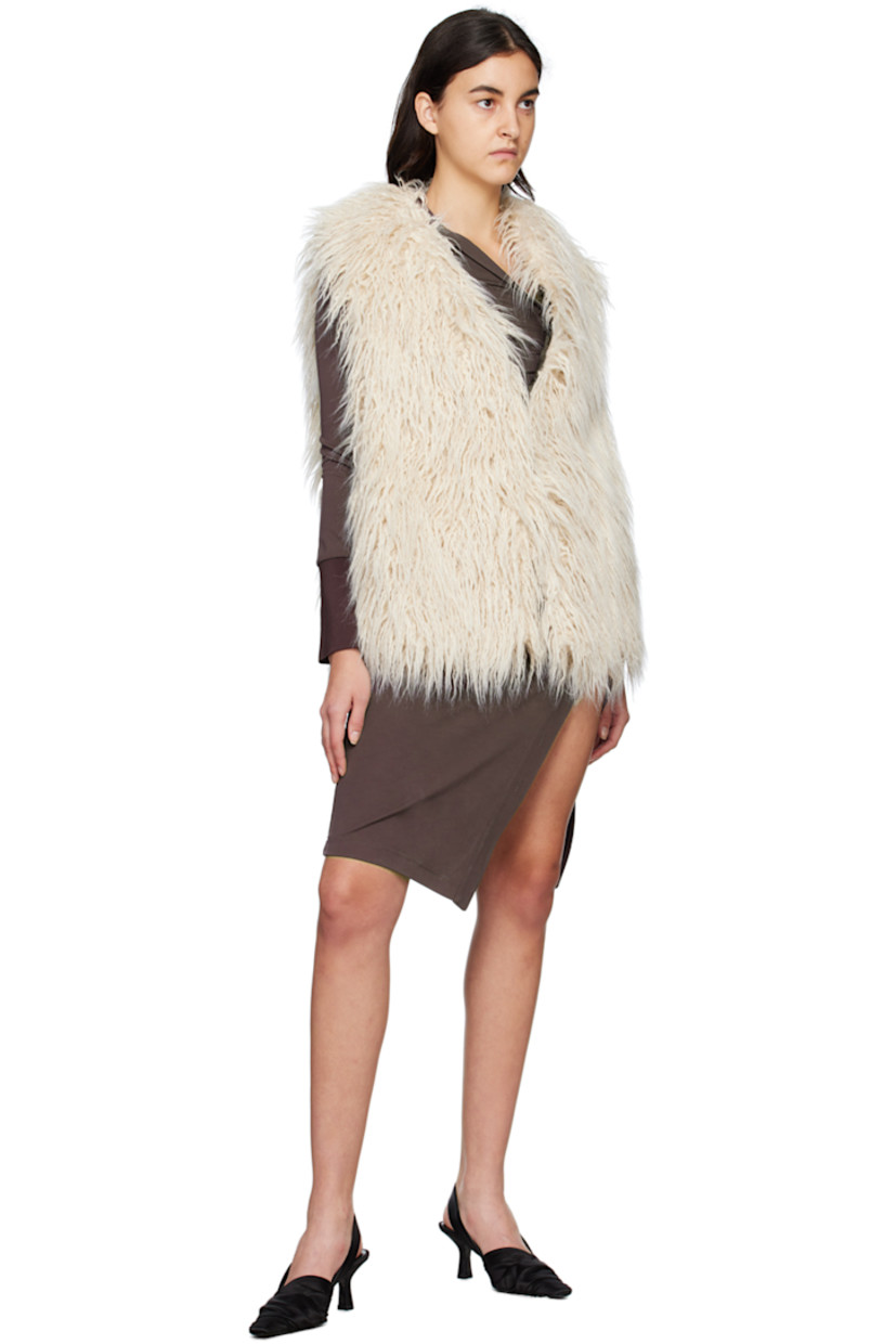 Acrylic-blend faux-fur vest. 

· V-neck 
· Concealed hook-eye closure 
· Welt pockets 
· Full satin lining 

Supplier color: Cream