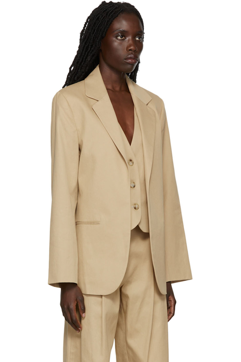 Cotton twill blazer featuring cotton twill vest underlay. 

· Notched lapel 
· Welt pockets 
· Button closure at vest underlay 
· Fully lined

Supplier color: Beige