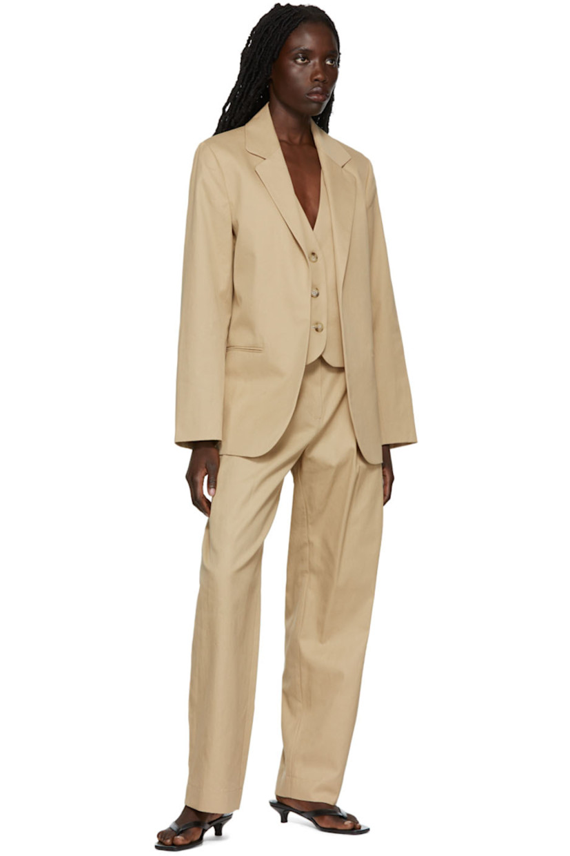 Cotton twill blazer featuring cotton twill vest underlay. 

· Notched lapel 
· Welt pockets 
· Button closure at vest underlay 
· Fully lined

Supplier color: Beige
