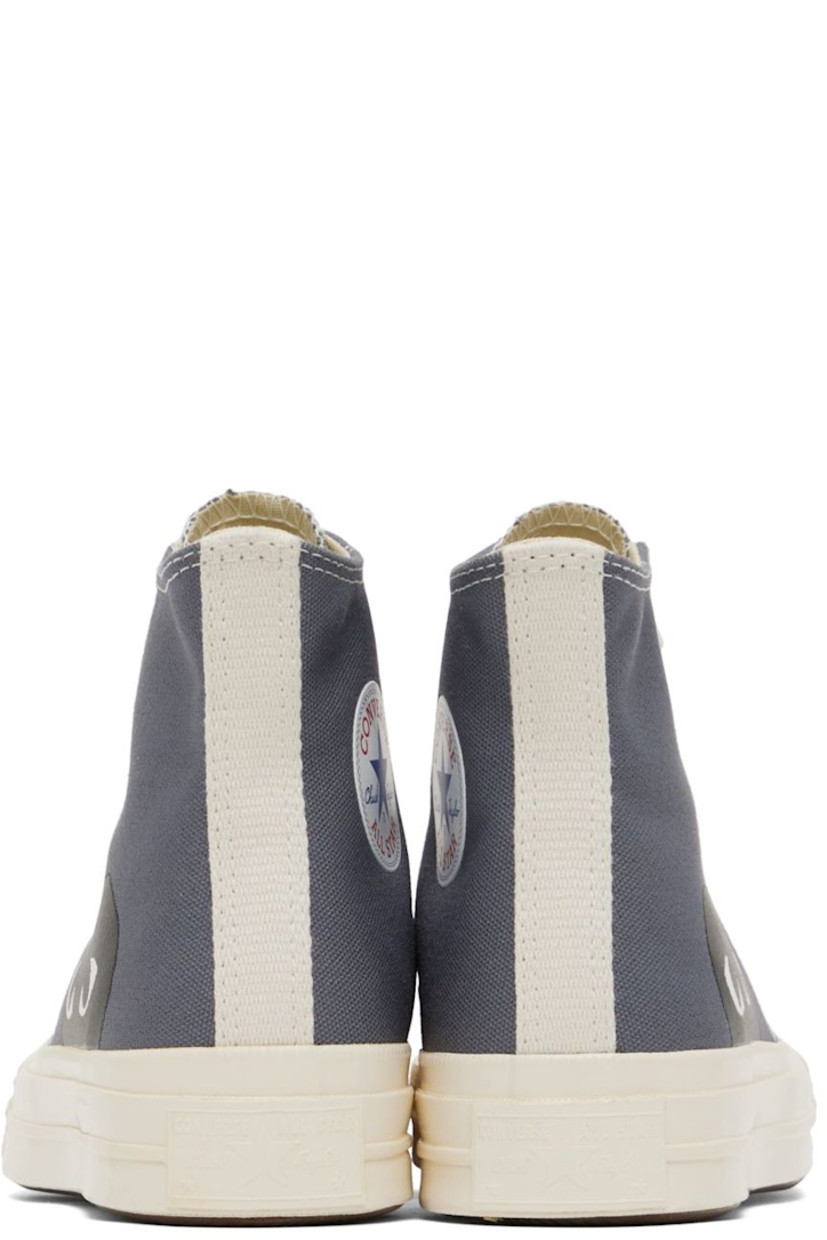 High-top canvas sneakers in gray. Logo graphic printed at outer side. 

· Round rubber cap toe 
· Lace-up closure 
· Eyelet vents and logo bonded at inner side
· Webbing trim in off-white at heel
· Ortholite® footbed 
· Rubber midsole in off-white with logo embossed at heel
· Treaded rubber outsole in brown
· Contrast stitching in white 

Part of the Comme des Garçons Play x Converse collaboration.

Supplier color: Steel gray/Egret/Black