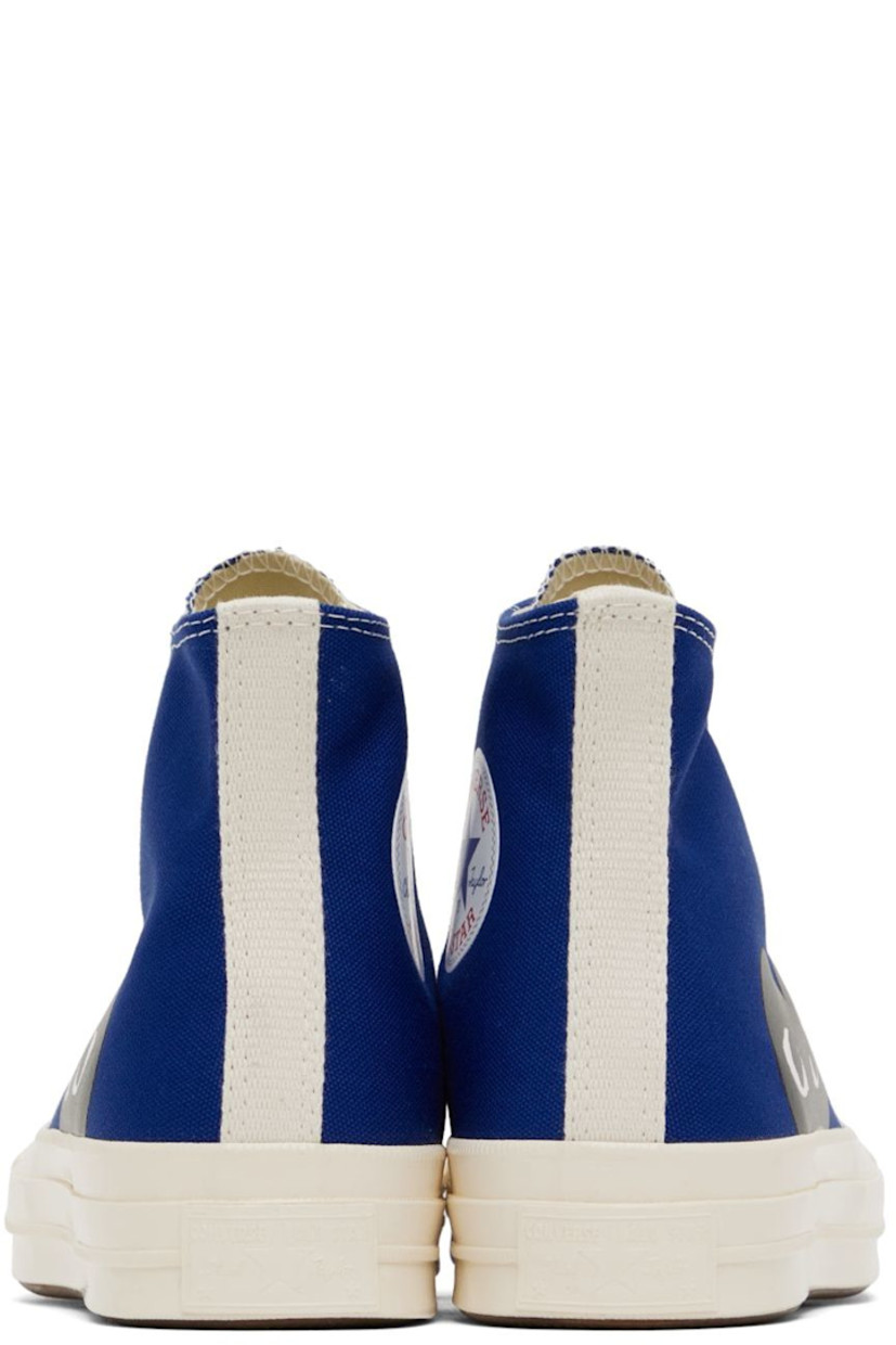 High-top canvas sneakers in blue. Logo graphic printed at outer side. 

· Round rubber cap toe 
· Lace-up closure 
· Logo bonded at inner side
· Webbing trim in off-white at heel
· Ortholite® footbed 
· Rubber midsole in off-white with logo embossed at heel
· Treaded rubber outsole in brown
· Contrast stitching in white 

Part of the Comme des Garçons Play x Converse collaboration.

Supplier color: Blue