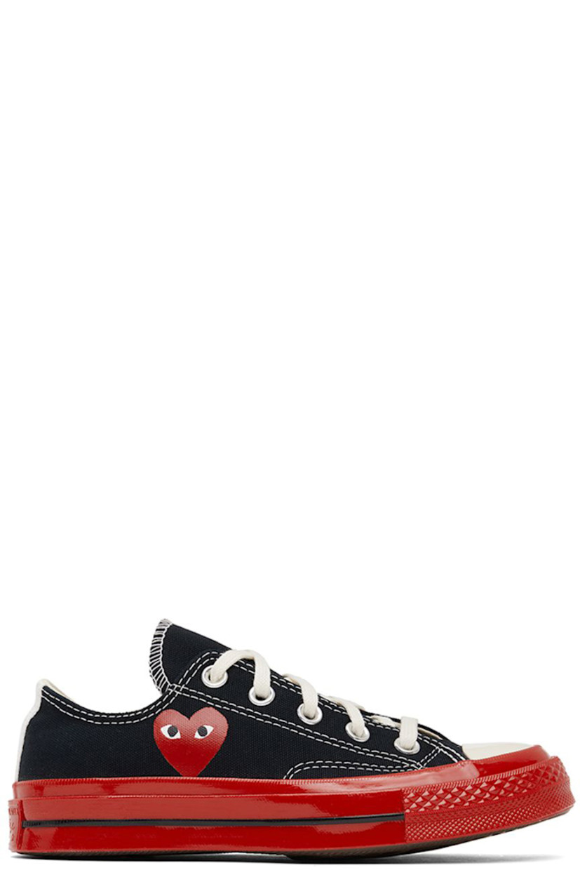 Low-top canvas sneakers in black.

· Round rubber cap toe
· Lace-up closure
· Logo graphic printed at outer side
· Eyelet vents at inner side
· Webbing trim and logo embossed at heel
· Treaded rubber sole

Part of the Comme des Garçons Play x Converse collaboration.

Supplier color: Black