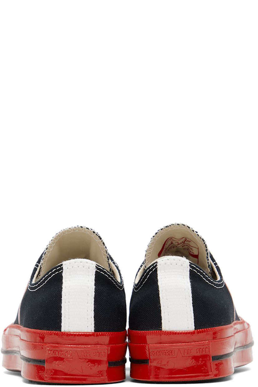 Low-top canvas sneakers in black.

· Round rubber cap toe
· Lace-up closure
· Logo graphic printed at outer side
· Eyelet vents at inner side
· Webbing trim and logo embossed at heel
· Treaded rubber sole

Part of the Comme des Garçons Play x Converse collaboration.

Supplier color: Black