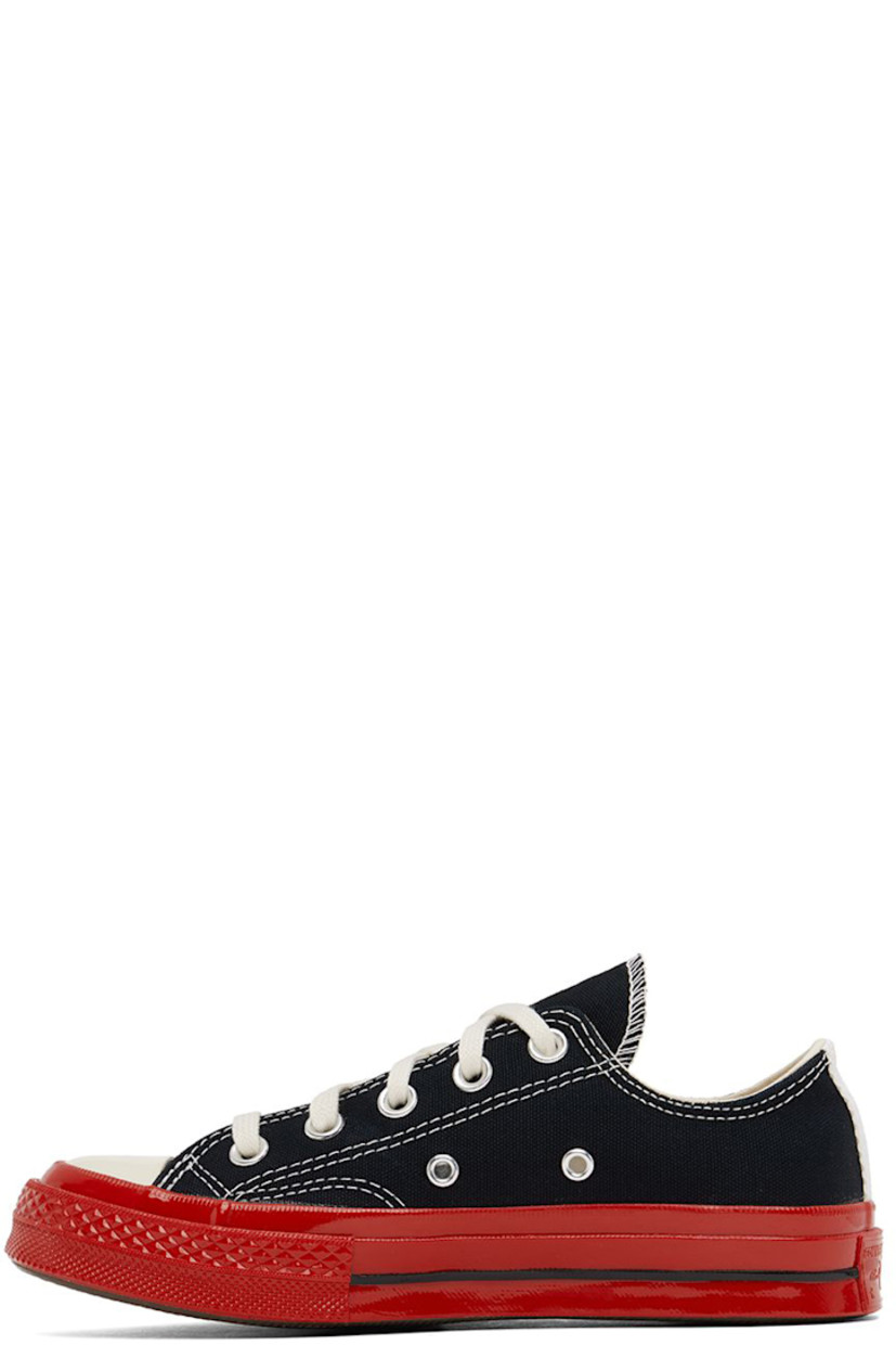 Low-top canvas sneakers in black.

· Round rubber cap toe
· Lace-up closure
· Logo graphic printed at outer side
· Eyelet vents at inner side
· Webbing trim and logo embossed at heel
· Treaded rubber sole

Part of the Comme des Garçons Play x Converse collaboration.

Supplier color: Black