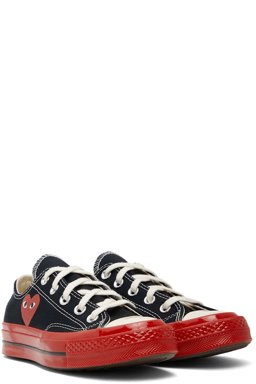 Low-top canvas sneakers in black.

· Round rubber cap toe
· Lace-up closure
· Logo graphic printed at outer side
· Eyelet vents at inner side
· Webbing trim and logo embossed at heel
· Treaded rubber sole

Part of the Comme des Garçons Play x Converse collaboration.

Supplier color: Black