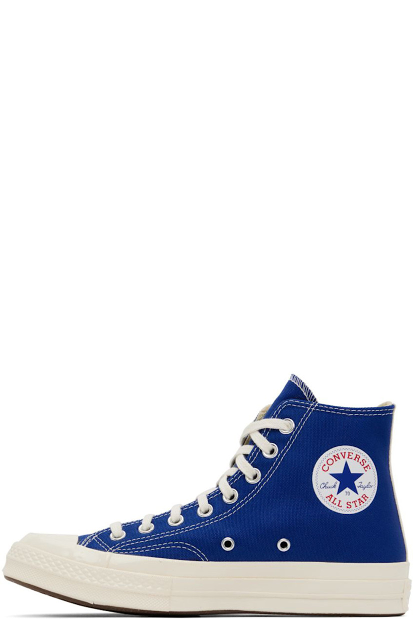High-top canvas sneakers in blue. Logo graphic printed at outer side. 

· Round rubber cap toe 
· Lace-up closure 
· Logo bonded at inner side
· Webbing trim in off-white at heel
· Ortholite® footbed
· Rubber midsole with logo embossed at heel
· Treaded rubber outsole in brown
· Contrast stitching in white 

Part of the Comme des Garçons Play x Converse collaboration.

Supplier color: Blue