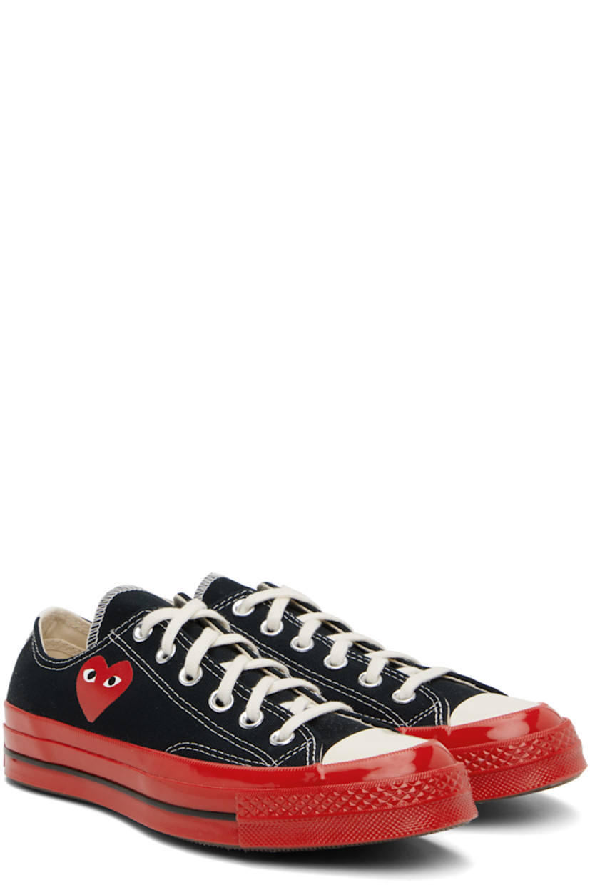 Low-top canvas sneakers in black.

· Round rubber cap toe
· Lace-up closure
· Logo graphic printed at outer side
· Eyelet vents at inner side
· Rubberized logo patch at heel
· Treaded rubber sole

Part of the Comme des Garçons Play x Converse collaboration.

Supplier color: Black