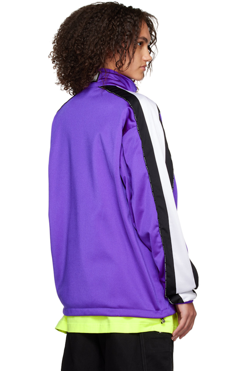 Nylon-blend jersey track jacket.

· Stand collar
· Two-way zip closure
· Text bonded at chest
· Concealed zip pockets
· Concealed bungee-style drawstring at hem
· Dropped shoulders
· Text-woven piping  and striped trim at sleeves
· Rib knit cuffs
· Rubberized graphic patch at back collar
· Full mesh lining

Supplier color: Purple/Black