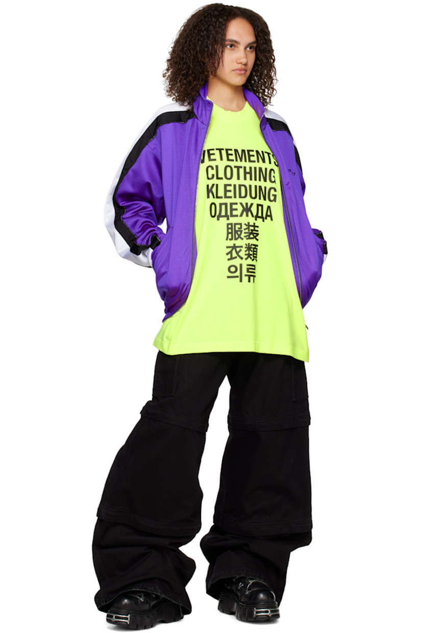 Nylon-blend jersey track jacket.

· Stand collar
· Two-way zip closure
· Text bonded at chest
· Concealed zip pockets
· Concealed bungee-style drawstring at hem
· Dropped shoulders
· Text-woven piping  and striped trim at sleeves
· Rib knit cuffs
· Rubberized graphic patch at back collar
· Full mesh lining

Supplier color: Purple/Black