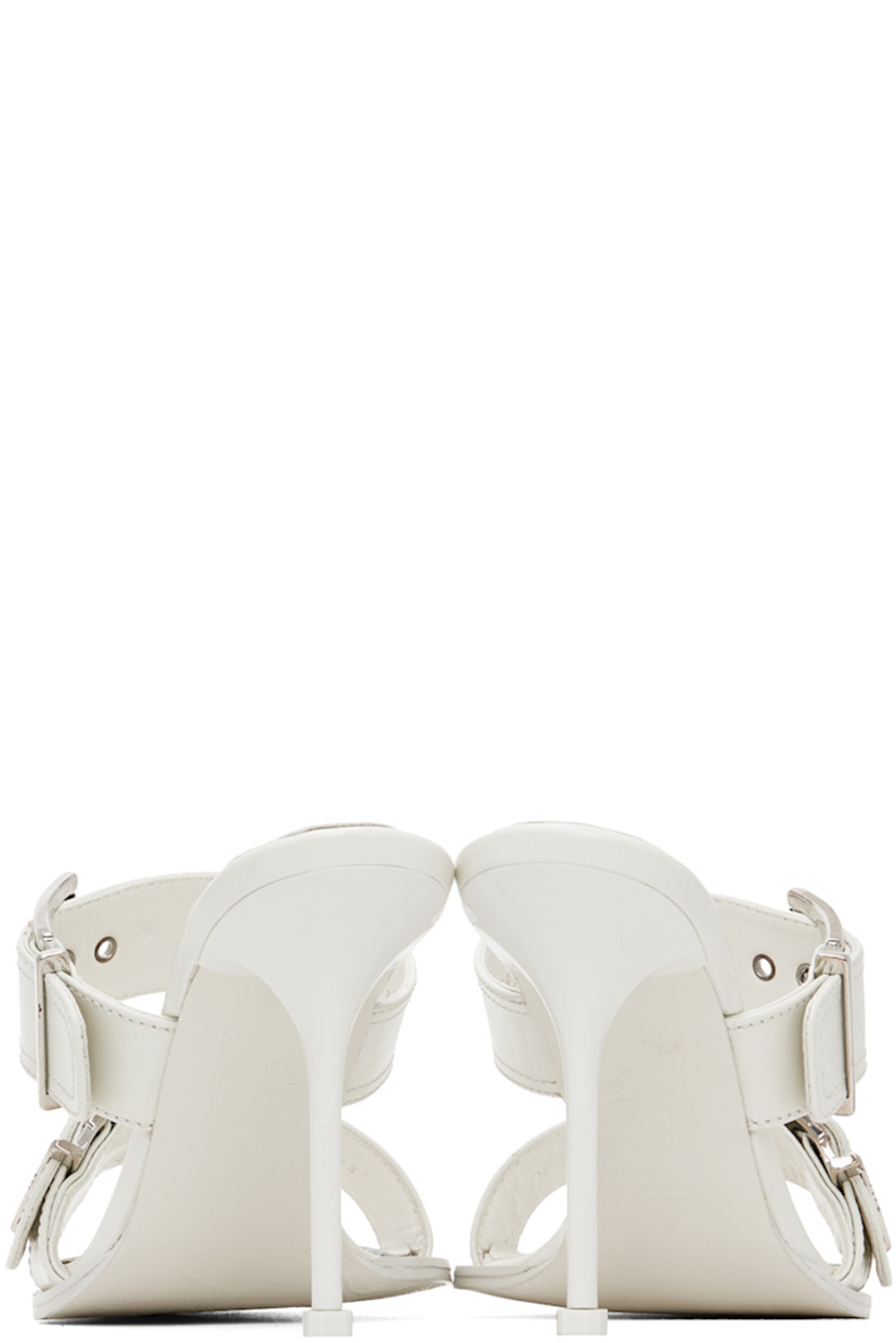 Buffed calfskin slip-on heeled sandals in white.

· Open square toe
· Adjustable pin-buckle straps at vamp
· Logo embossed at padded footbed
· Stiletto heel with rubber injection
· Leather outsole
· Heel: H4.25 in

Supplier color: New ivory/Silver