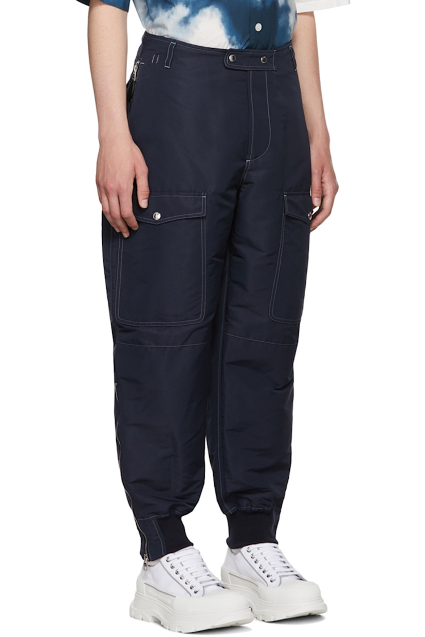 Recycled polyester faille cargo pants. Stretch silk faille trim throughout.

· Belt loops
· Zip-fly
· Adjustable buttoned tab at waistband 
· Flap pockets 
· Cinch strap at back waistband
· Four-pocket styling
· Zip at vented elasticized rib knit cuffs
· Contrast stitching in white

Supplier color: Navy