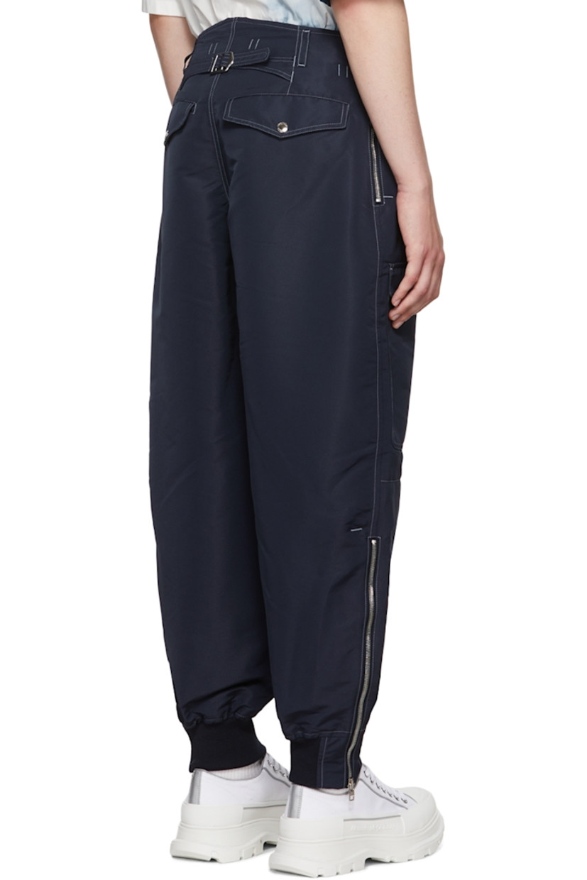 Recycled polyester faille cargo pants. Stretch silk faille trim throughout.

· Belt loops
· Zip-fly
· Adjustable buttoned tab at waistband 
· Flap pockets 
· Cinch strap at back waistband
· Four-pocket styling
· Zip at vented elasticized rib knit cuffs
· Contrast stitching in white

Supplier color: Navy