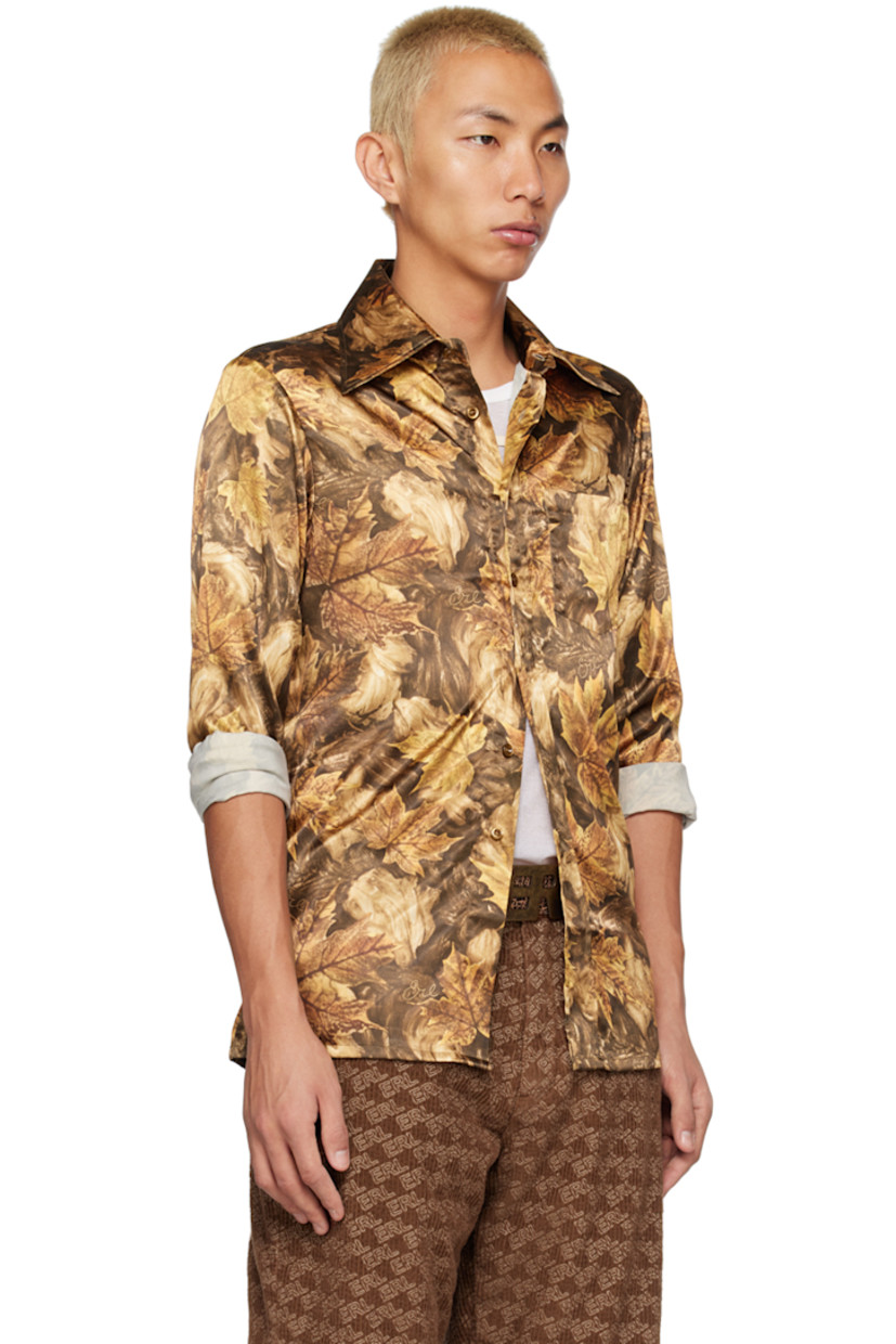 Stretch polyester satin shirt. Graphic pattern and logo printed throughout. 

· Spread collar 
· Button closure 
· Pach pockets
· Single-button barrel cuffs 

Supplier color: Brown