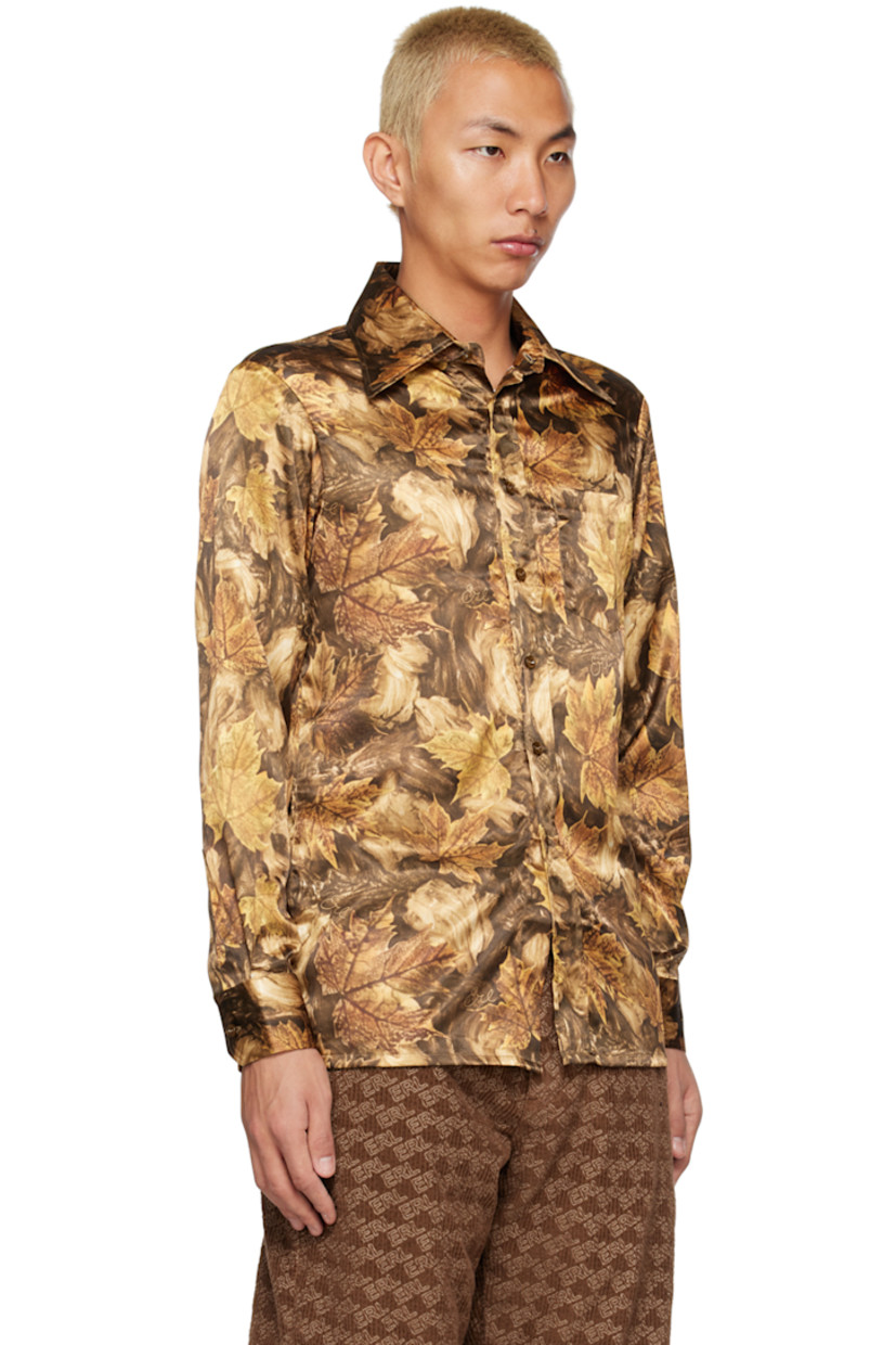 Stretch polyester satin shirt. Graphic pattern and logo printed throughout. 

· Spread collar 
· Button closure 
· Pach pockets
· Single-button barrel cuffs 

Supplier color: Brown