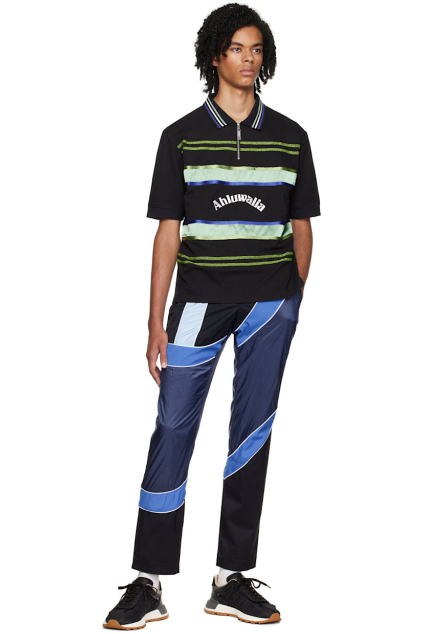 Organic cotton piqué polo. 

· Spread collar
· Half-zip closure
· Beaded detailing and satin trim at front
· Vented side seams

Supplier color: Black