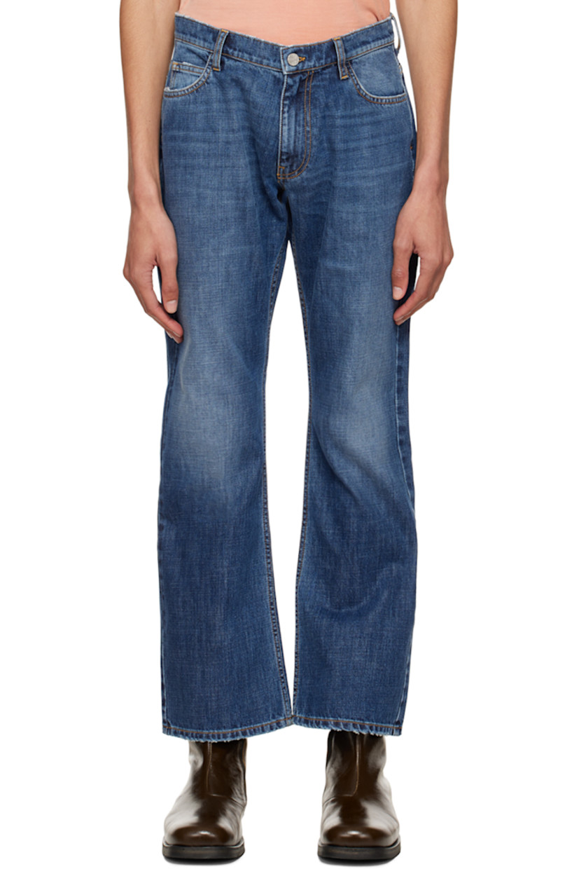 Non-stretch denim jeans. Distressing throughout. 

· Belt loops
· Five-pocket styling
· Zip-fly
· Logo graphic embroidered at back
· Rubberized logo flag at back
· Logo-engraved silver-tone hardware
· Contrast stitching in tan

Supplier color: Blue denim
