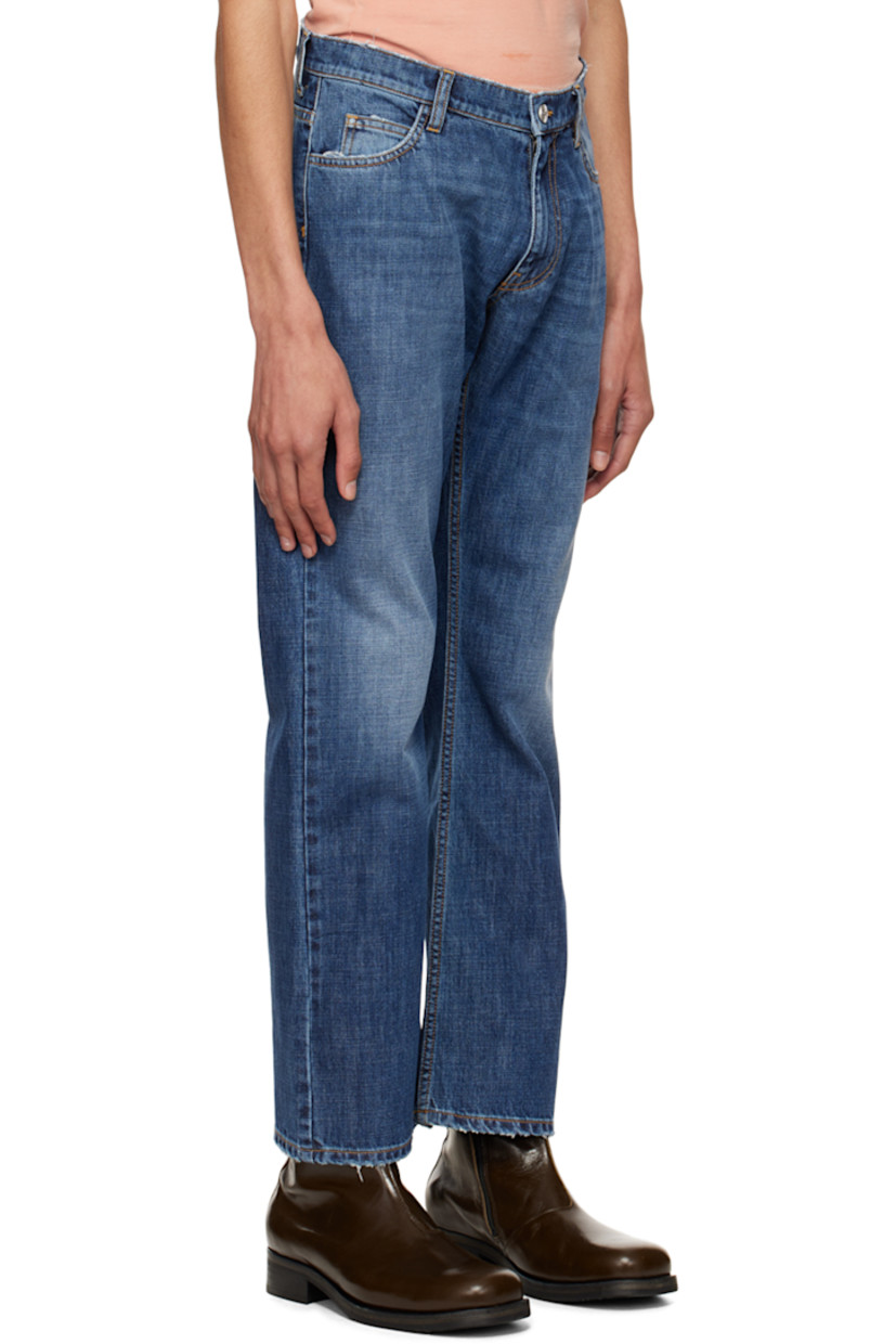 Non-stretch denim jeans. Distressing throughout. 

· Belt loops
· Five-pocket styling
· Zip-fly
· Logo graphic embroidered at back
· Rubberized logo flag at back
· Logo-engraved silver-tone hardware
· Contrast stitching in tan

Supplier color: Blue denim