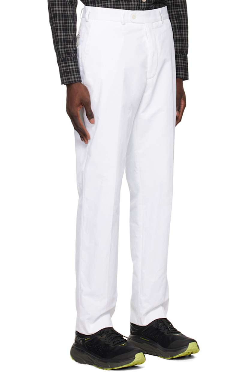 Nylon twill trousers. Logo pattern embroidered throughout.

· Belt loops
· Three-pocket styling
· Zip-fly
· Creased legs
· Darts at back waistband
· Rubberized logo patch at back

Supplier color: White