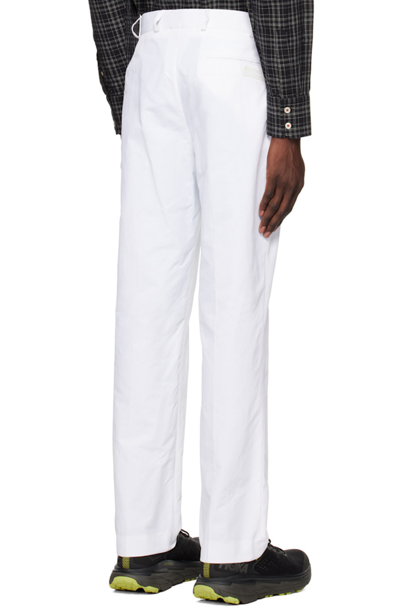Nylon twill trousers. Logo pattern embroidered throughout.

· Belt loops
· Three-pocket styling
· Zip-fly
· Creased legs
· Darts at back waistband
· Rubberized logo patch at back

Supplier color: White
