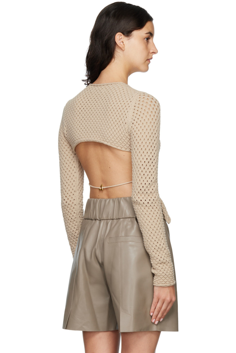 Knit stretch Ecovero™ viscose and polyester-blend sweater. 

· Rolled edge at crewneck, cuffs, and hem
· Cutout at back
· Hand-crocheted strap at back 
· Logo plaque at back 

Supplier color: Sand
