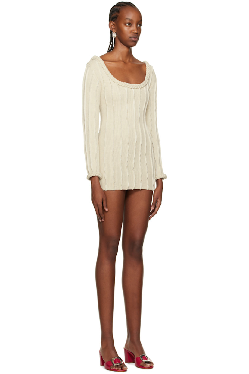 Waffle knit stretch cotton dress. Pinched seams throughout.

· V-neck at spread collar
· Braided detailing at cuffs
· Press-stud closure at bottom
· Contrast stitching in white 

Supplier color: Beige